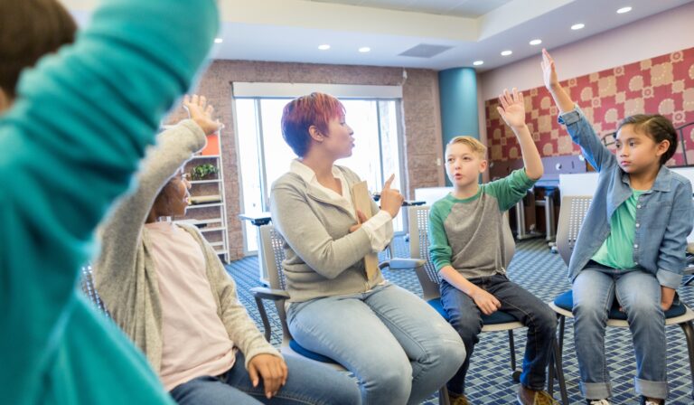 teacher and students participating in a group discussion