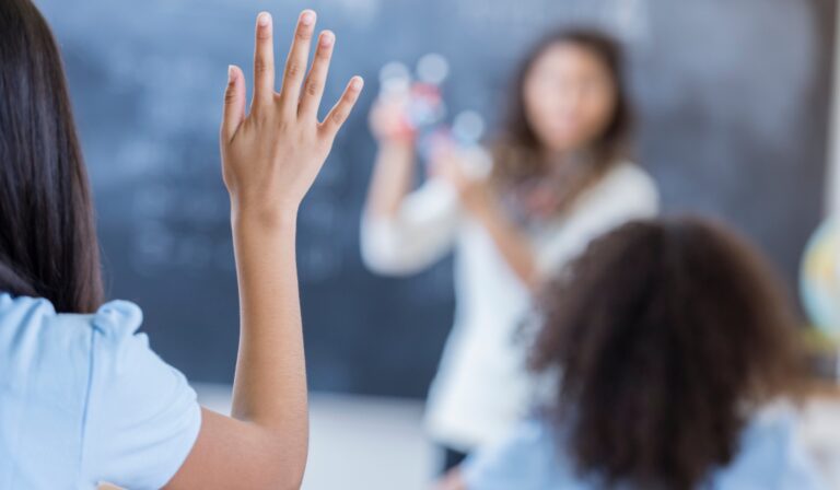 student raising hand in class