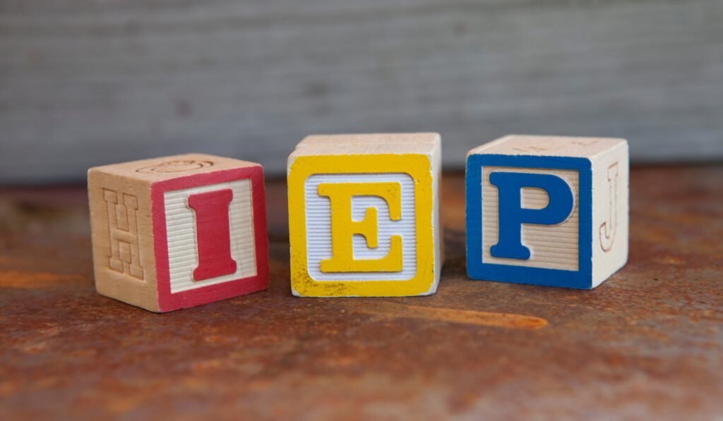 The letters IEP written on 3 differently colored blocks