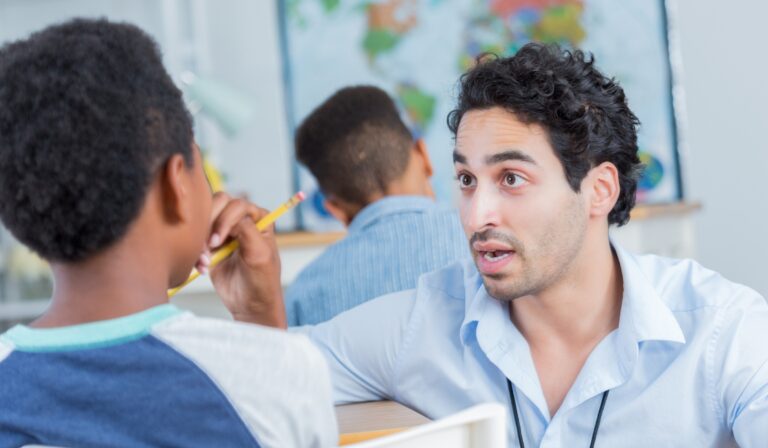 teacher providing behavior correction to student