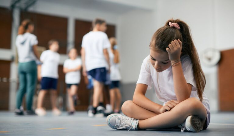 child left out sitting in gym class alone