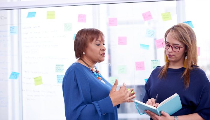 two women talking about behavior baseline data