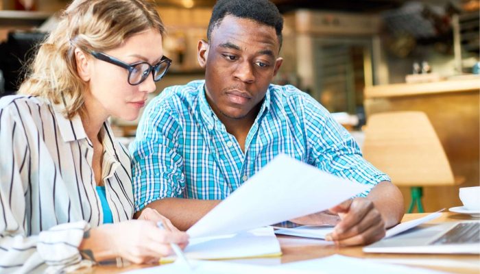 two people looking at a report