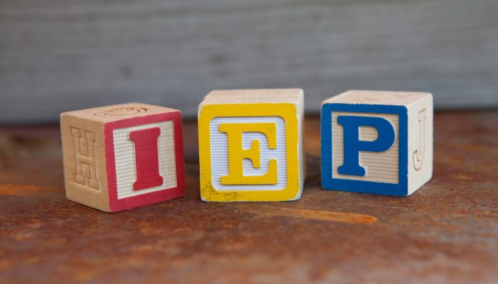 The letters IEP written on 3 differently colored blocks