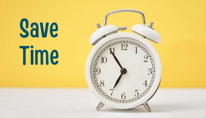 White clock on table, yellow wall