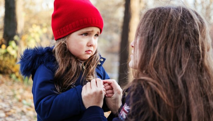 an adult helps a child learn to express their emotions