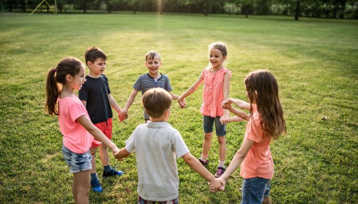 group of children holding hands in a circle