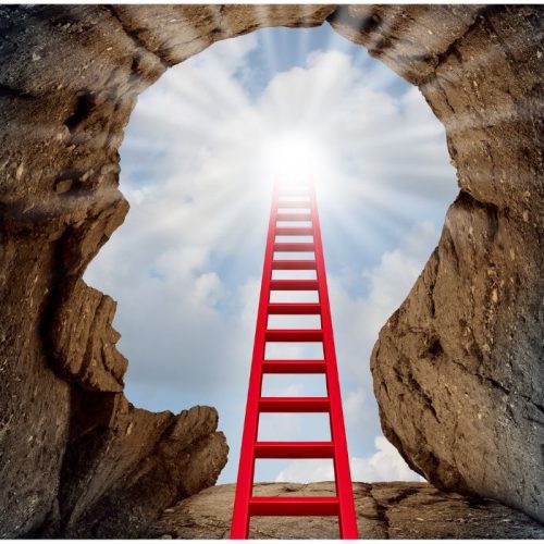 head shaped cave with ladder leading up to sunny sky - open mind