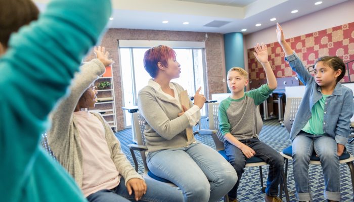 teacher and students participating in a group discussion