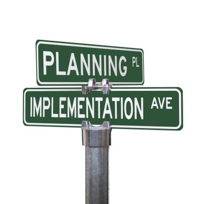 signpost at the corner of planning and implementation roads