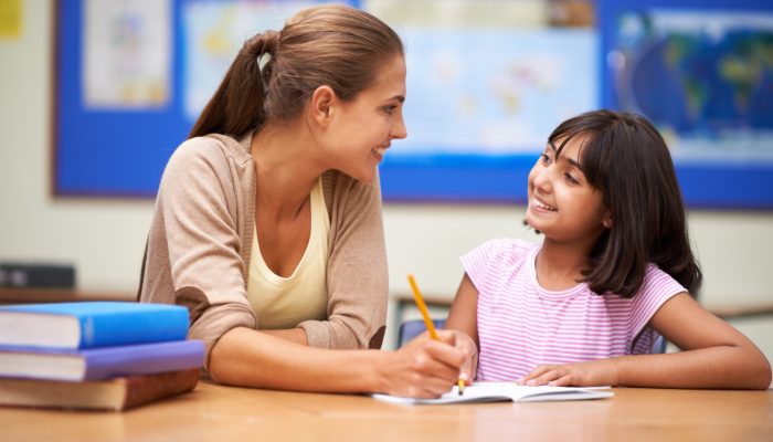 an adult offers a student praise and encouragement