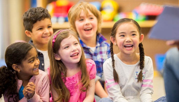 children listening to teacher read an engaging book