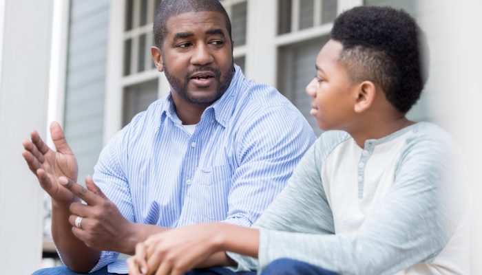 child sitting and talking with an adult - showing respect