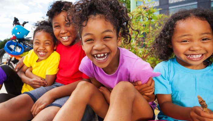 smiling children sitting outside