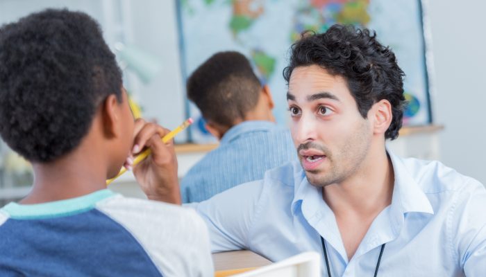 teacher providing behavior correction to student