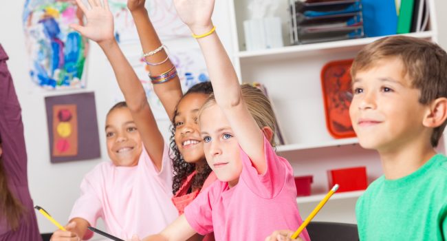 students raising hands