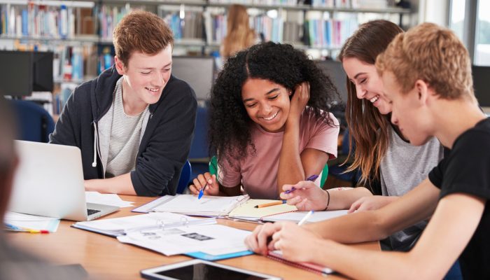 teen students working in library